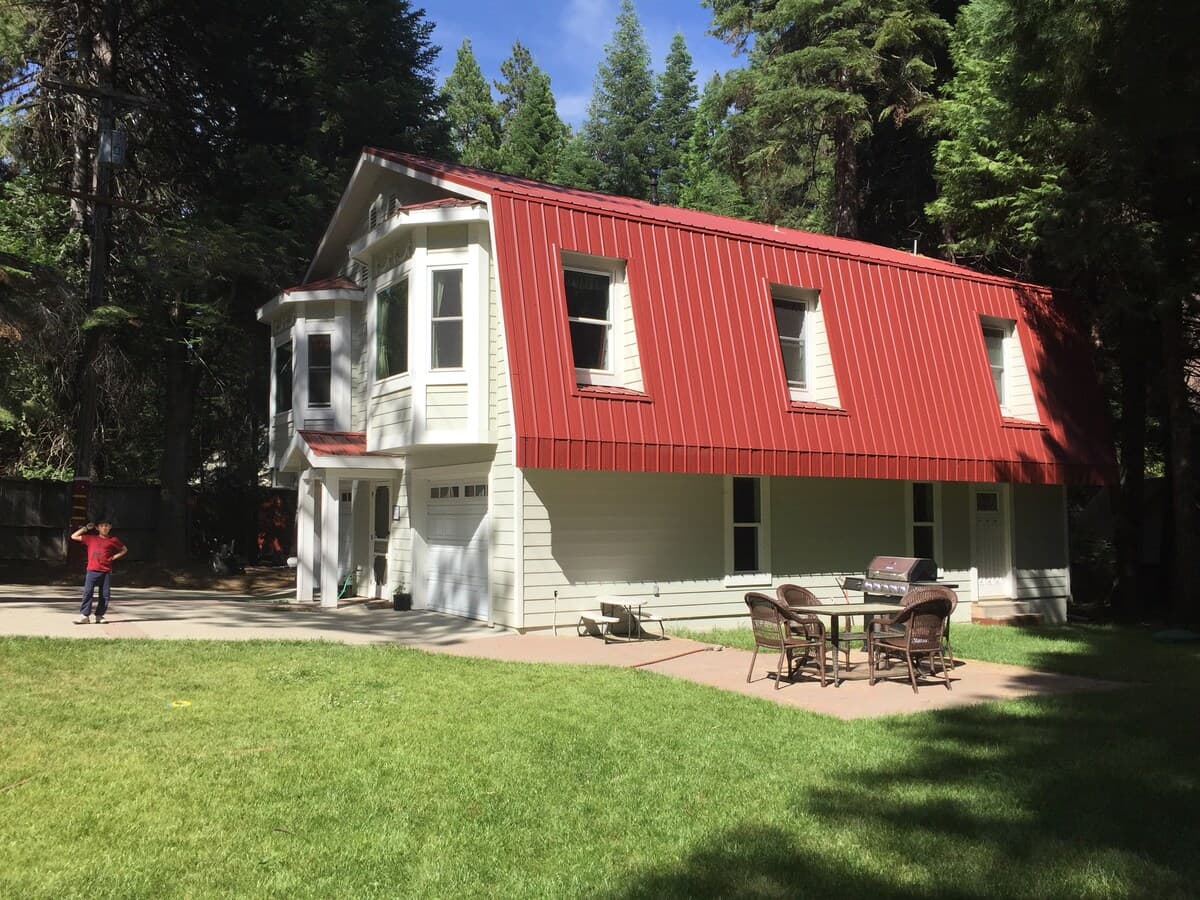 Exterior view of the Carriage House with patio table and grill