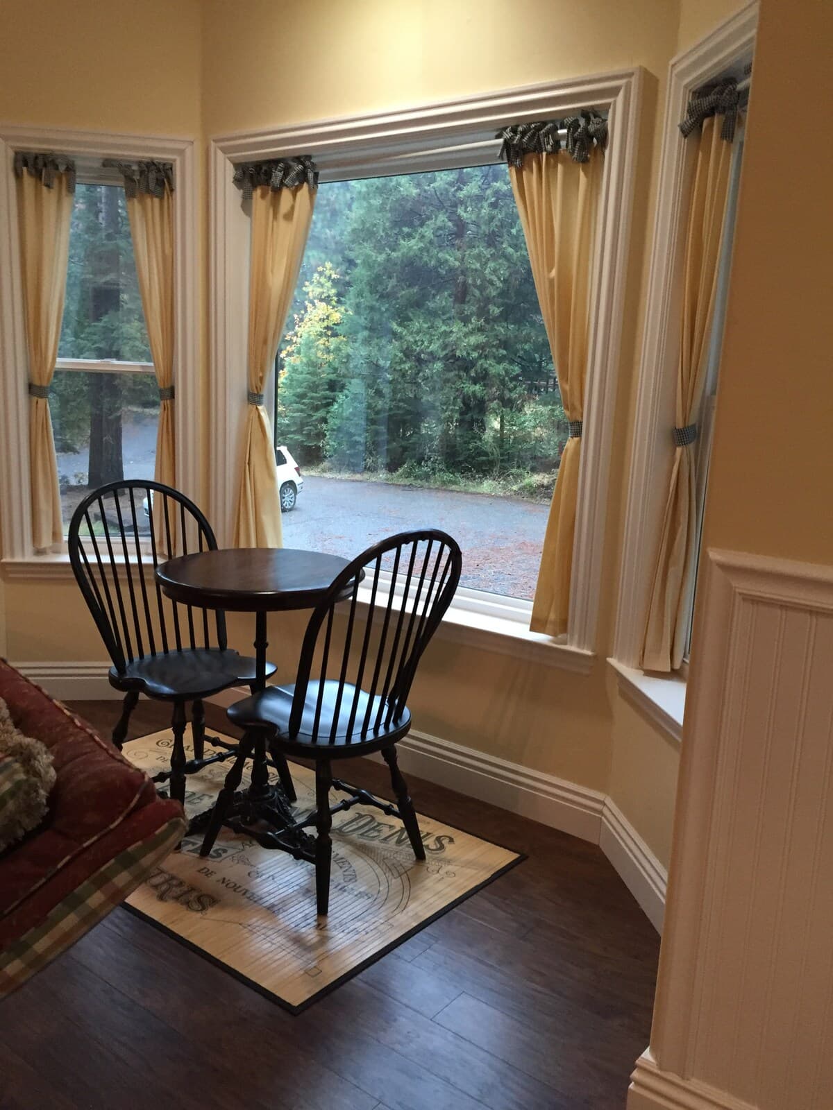 Small round breakfast table by large picture windows